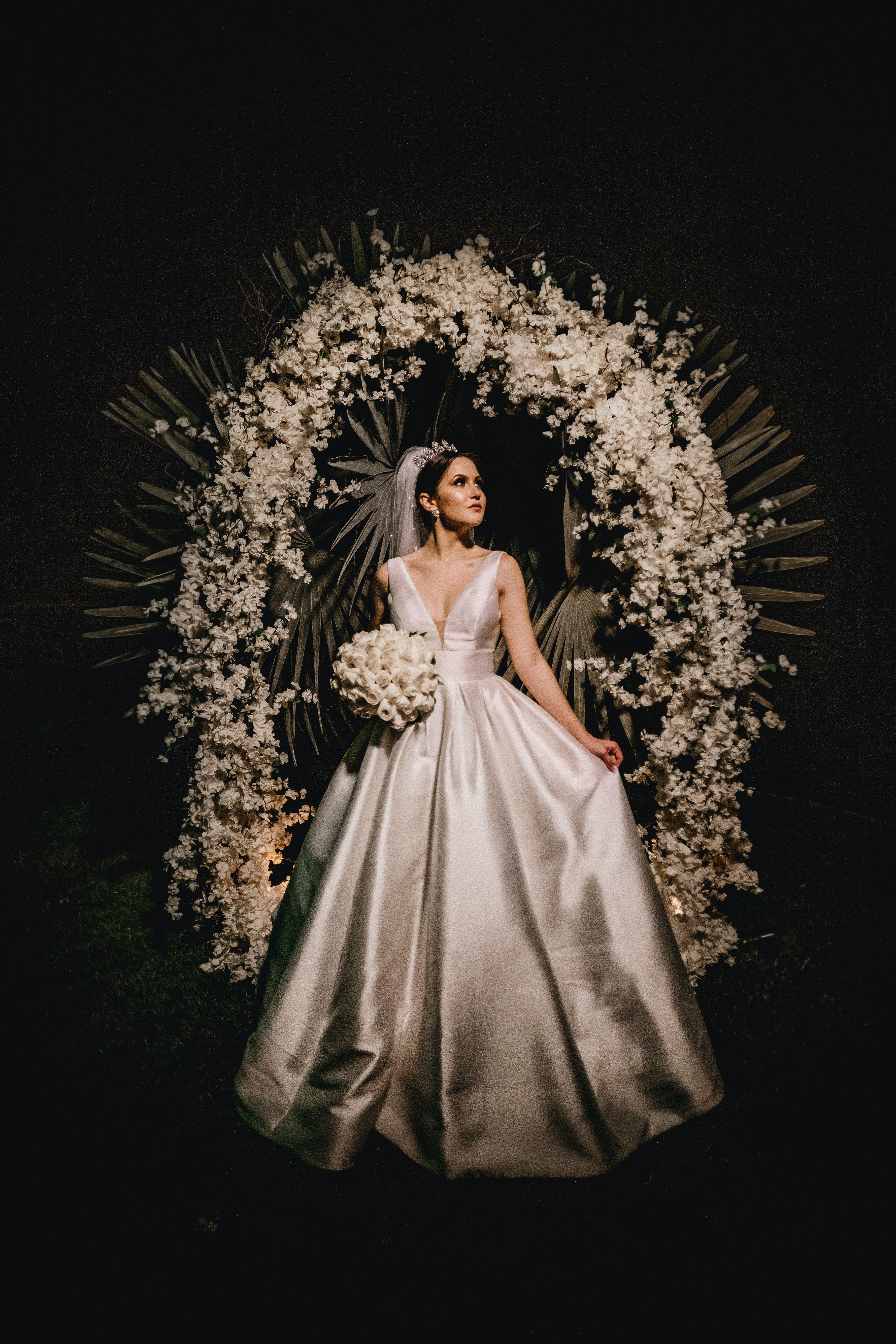 Bride in front of a White Floral-Backdrop-UnSplash