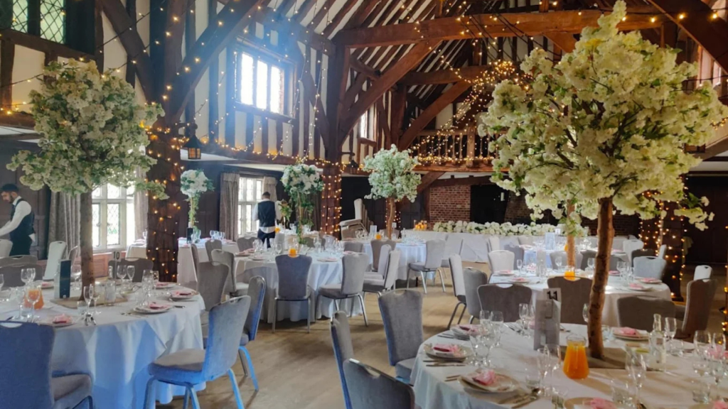 Elegant corporate event styling with floral centrepieces, branded décor, and modern table settings for a professional business event.